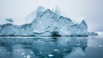 Iceberg and ice from glacier in arctic nature landscape in Ilulissat,Greenland. Aerial drone photo of icebergs in Ilulissat icefjord. Affected by climate change and global warming.