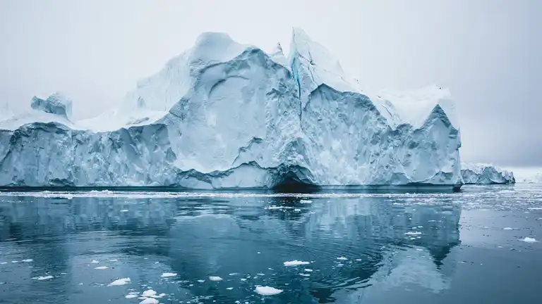 Iceberg and ice from glacier in arctic nature landscape in Ilulissat,Greenland. Aerial drone photo of icebergs in Ilulissat icefjord. Affected by climate change and global warming.