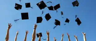 Graduation Caps Thrown in the Air on blue sky