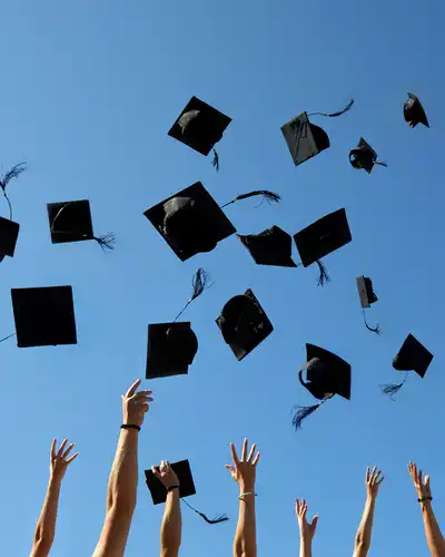 Graduation Caps Thrown in the Air on blue sky
