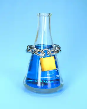 Freedom of science concept. A chain and a padlock wrapped around a laboratory glass flask.