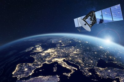 Telecommunication satellite providing global internet network and high speed data communication above Europe. Satellite in space, low Earth orbit. Worldwide communication technology.