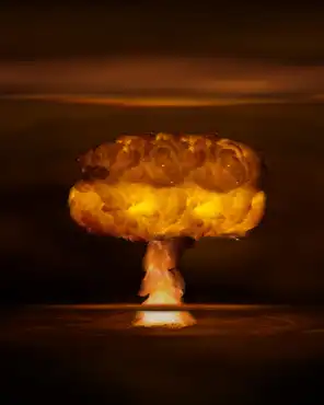 Atomic bomb realistic explosion, orange color with smoke on black background